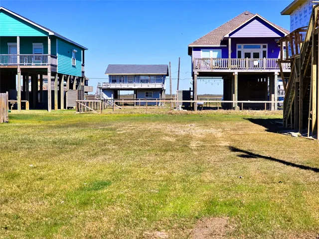 a view of a swimming pool with a lawn chairs under an umbrella