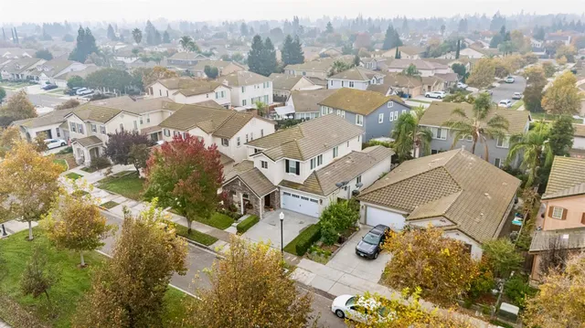 an aerial view of residential house with green space
