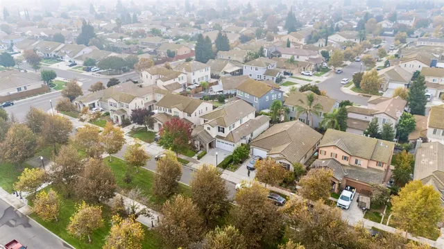 an aerial view of residential houses with yard