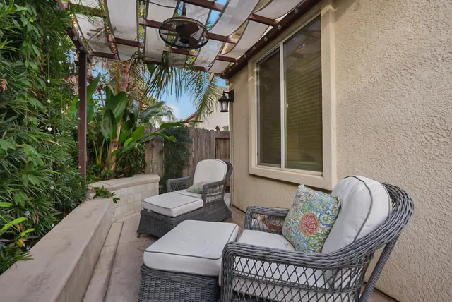 a view of a couches and dinning table in patio