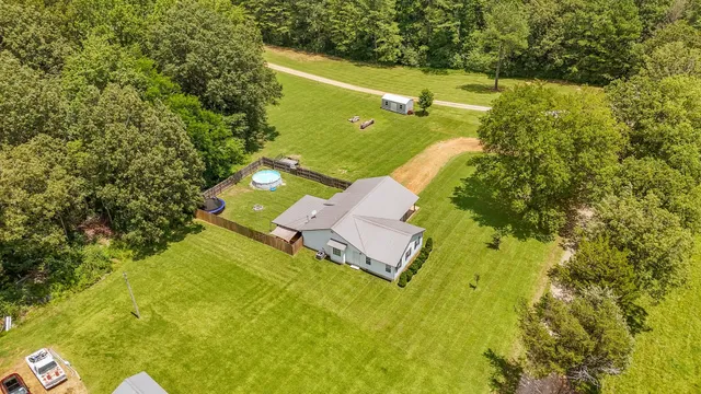 a view of a yard with swimming pool