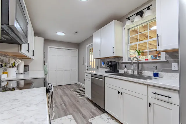 a dining room with furniture a chandelier and window