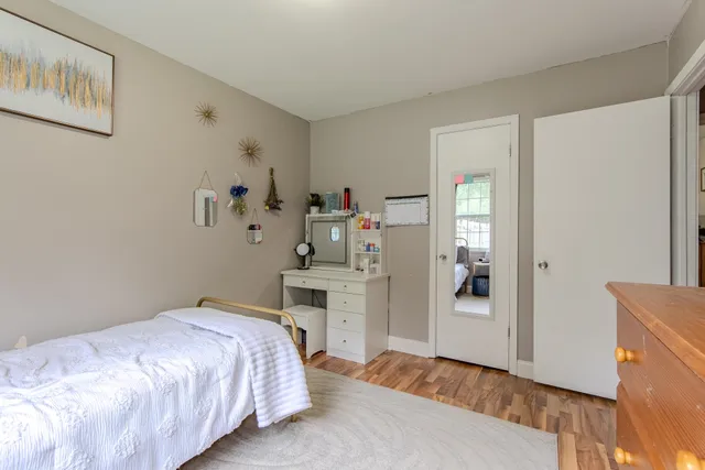 a bedroom with a bed and a dresser