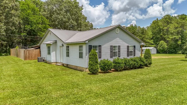 a view of a house with yard and a garden