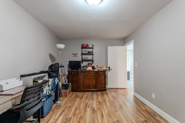a bedroom with furniture and a wooden floor