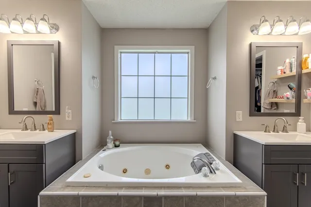 a bathroom with a sink a mirror and a shower