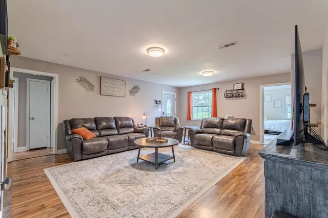 a living room with furniture and a rug