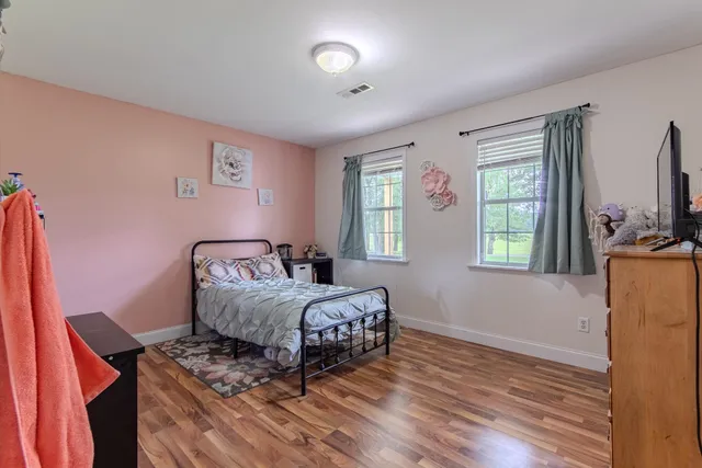 a bed room with two beds and a window