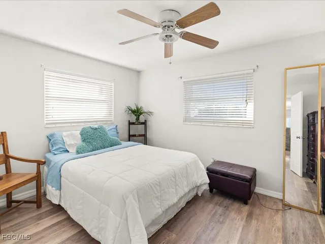 a bedroom with a bed table and a window