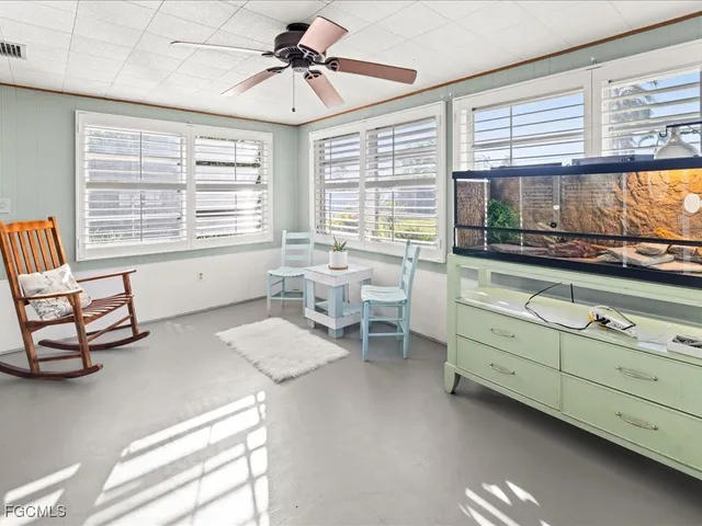 a living room with furniture and large windows