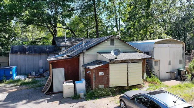 a view of a house with a yard and sitting area