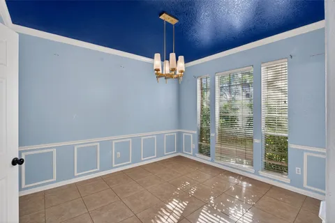 a white toilet sitting next to a white wall