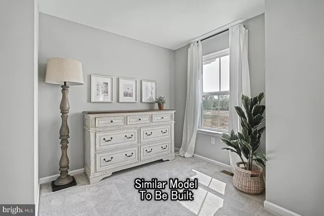 a view of a bedroom with a furniture and a potted plant