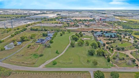 an aerial view of a residential houses with outdoor space