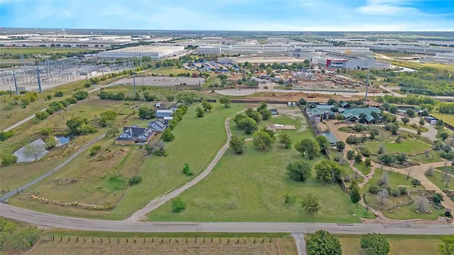 an aerial view of a residential houses with outdoor space