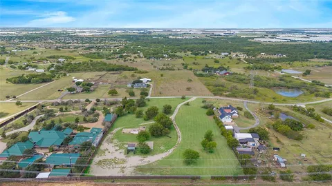 an aerial view of a residential houses with outdoor space