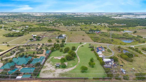 an aerial view of a residential houses with outdoor space
