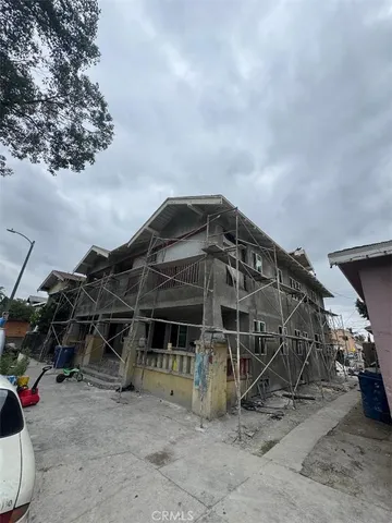 a view of a wooden door with a big yard and a barbeque