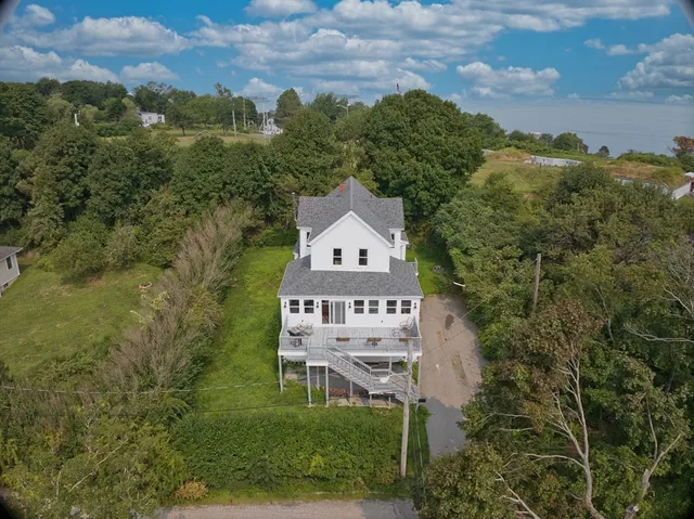 an aerial view of a house with a big yard