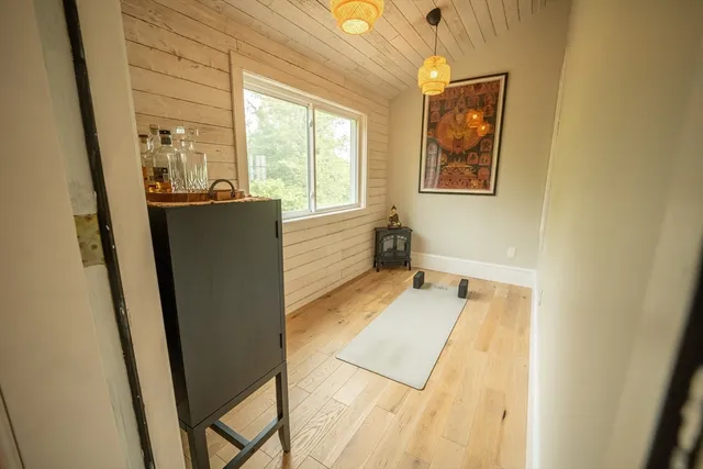 wooden floor in a room next to a window