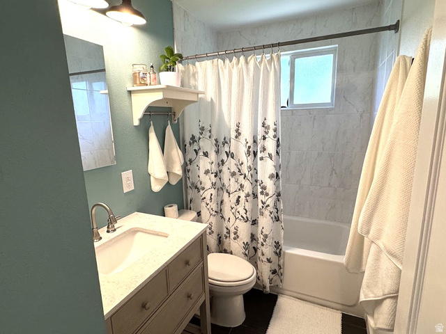 1791 West 170 South, Unit 8 Provo, UT 84601 - Photo 10 of 25 Bathroom featuring a vanity with an integrated sink and light-colored countertop, a toilet, and a combination shower/tub with tile surround