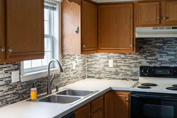 a kitchen with a sink and a stove top oven