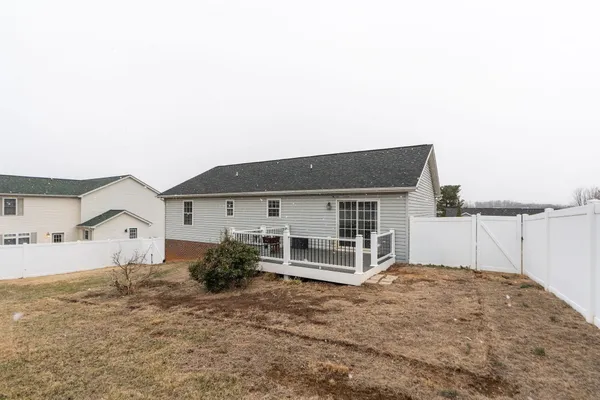 a view of house with backyard and garden