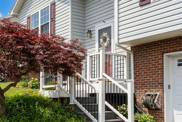 a view of a house with a tree front of house
