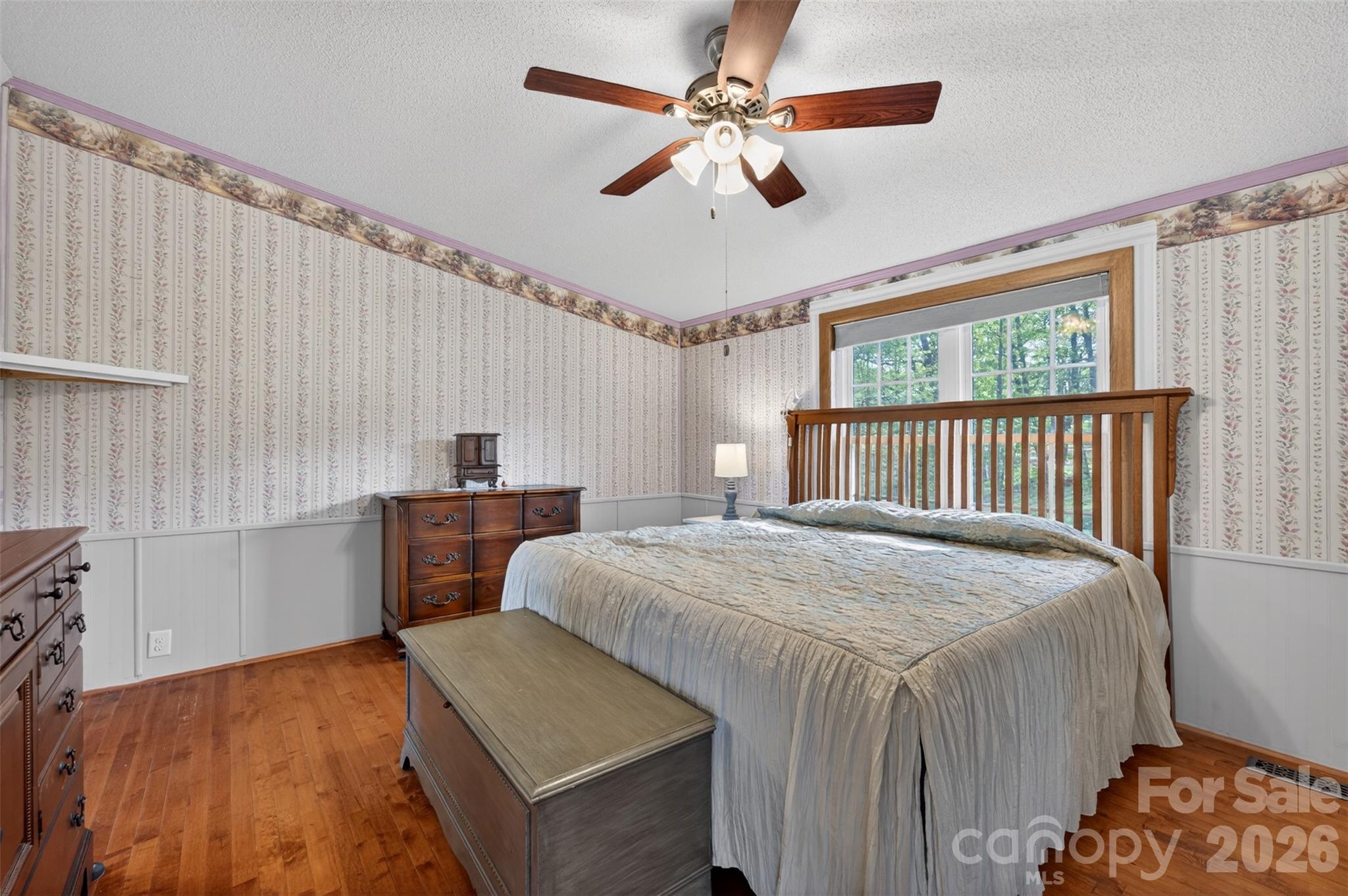 4352 Anderson Mountain Road Maiden, NC 28650 - Photo 16 of 42 a bedroom with a bed and a chandelier
