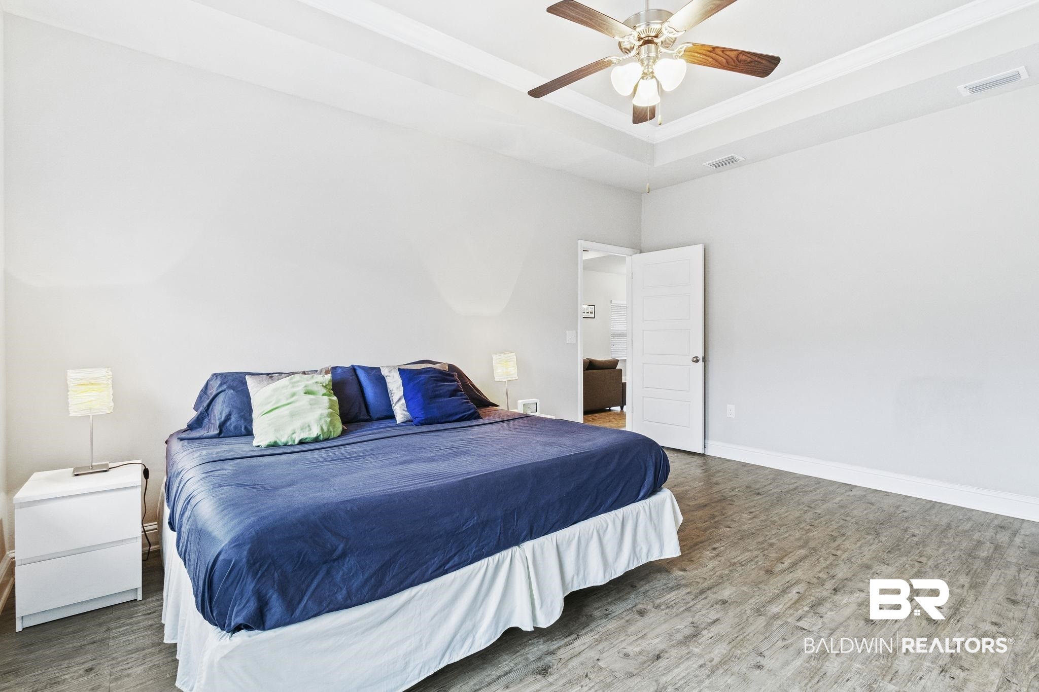 31643 Kestrel Loop Daphne, AL 36527 - Photo 21 of 59 Bedroom with a raised ceiling, ceiling fan, and hardwood / wood-style floors