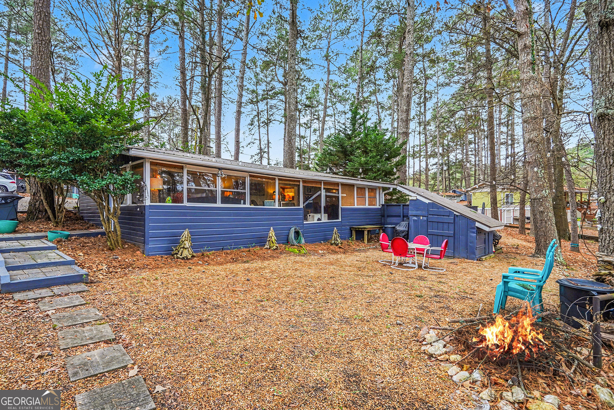 a view of a house with a yard and sitting area