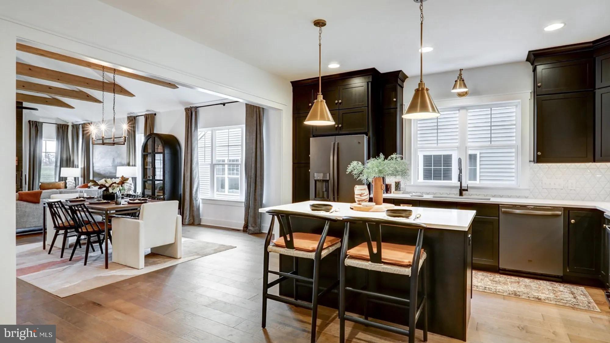 108 Flora Boulevard Lebanon, PA 17042 - Photo 44 of 44 a kitchen with stainless steel appliances granite countertop a stove a refrigerator a kitchen island a dining table and chairs with wooden floor