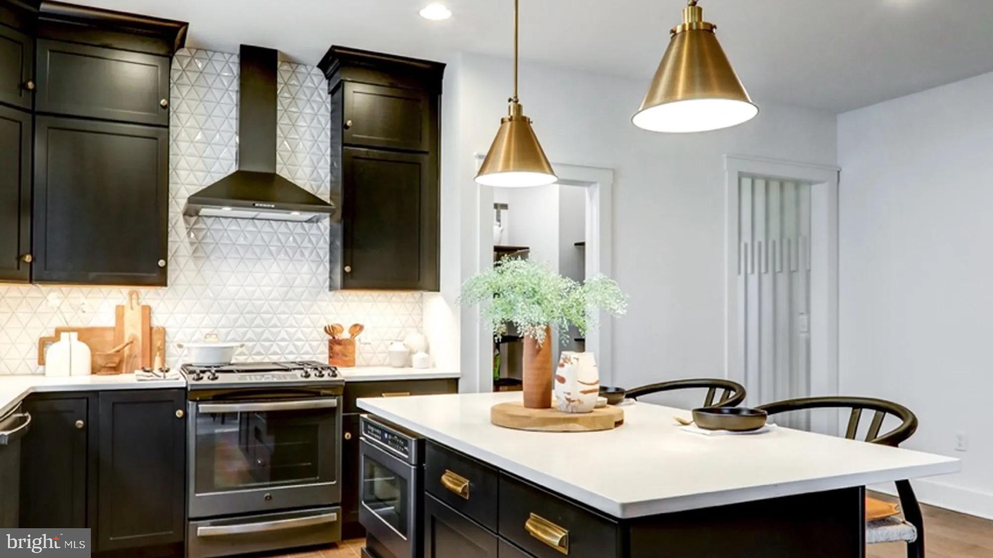 108 Flora Boulevard Lebanon, PA 17042 - Photo 7 of 44 a kitchen with a sink a kitchen island and stainless steel appliances
