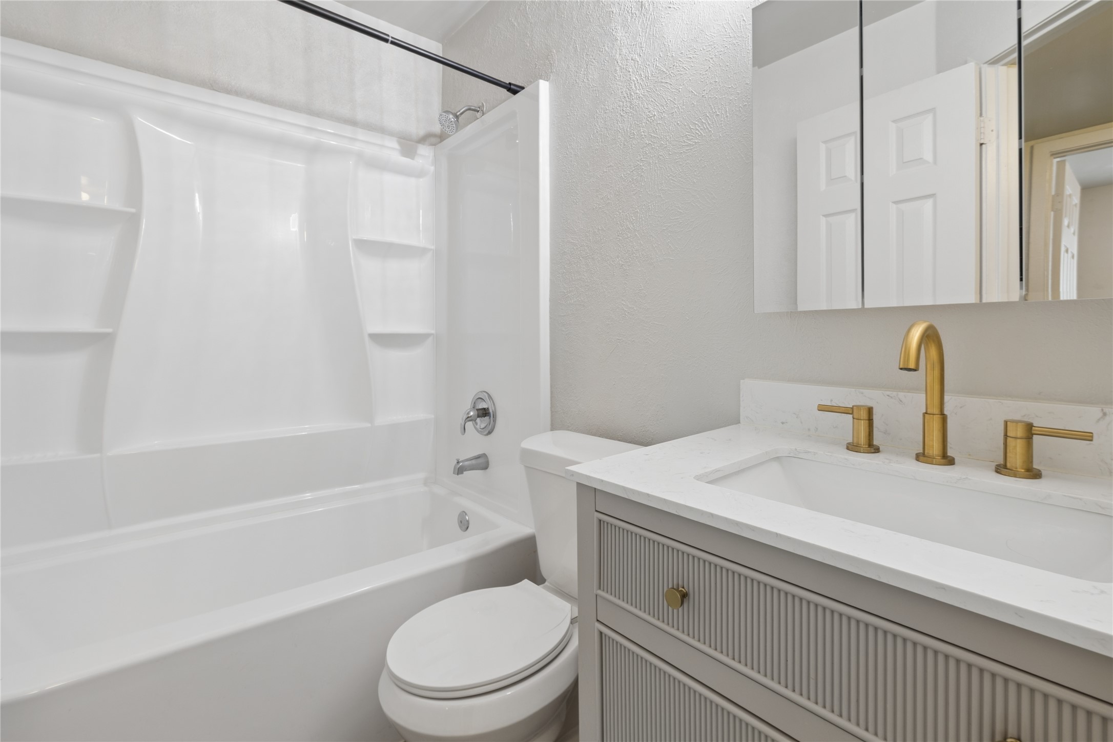 820 Sahara Avenue, Unit B Austin, TX 78745 - Photo 9 of 29 Full second floor bathroom featuring a textured wall, vanity, and shower / bath combination