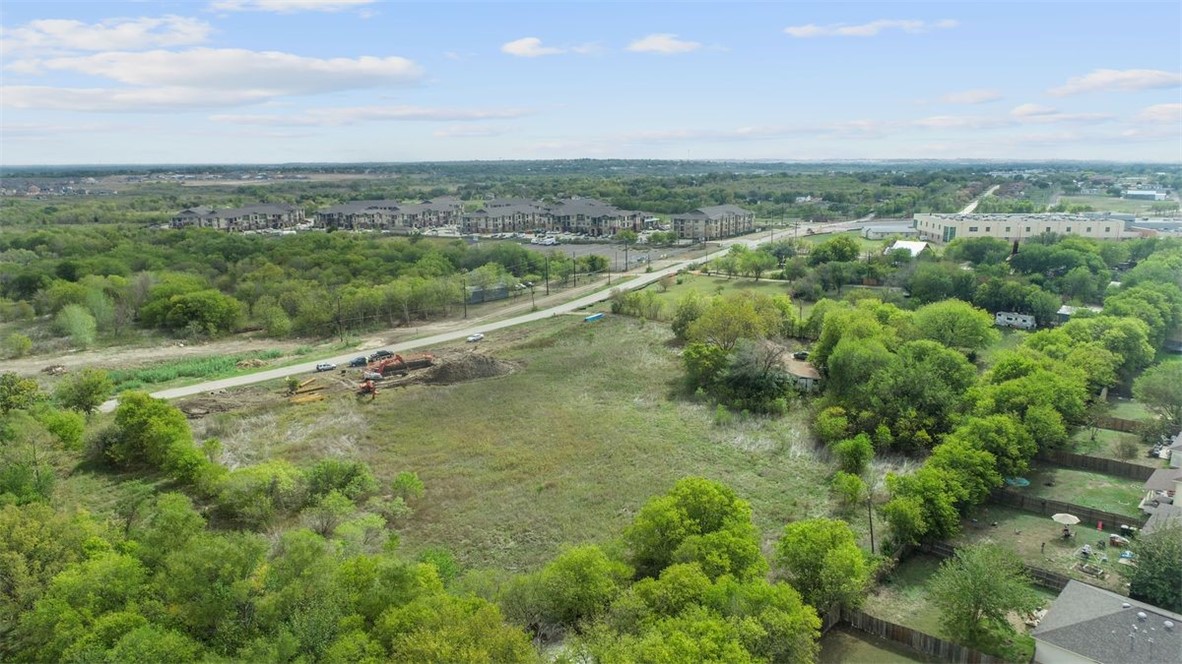 a view of a city with lush green forest
