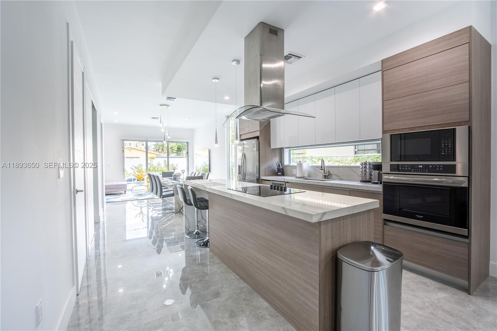 3461 Southwest 25th Street, Unit B Miami, FL 33133 - Photo 1 of 23 a kitchen with a sink stainless steel appliances and cabinets