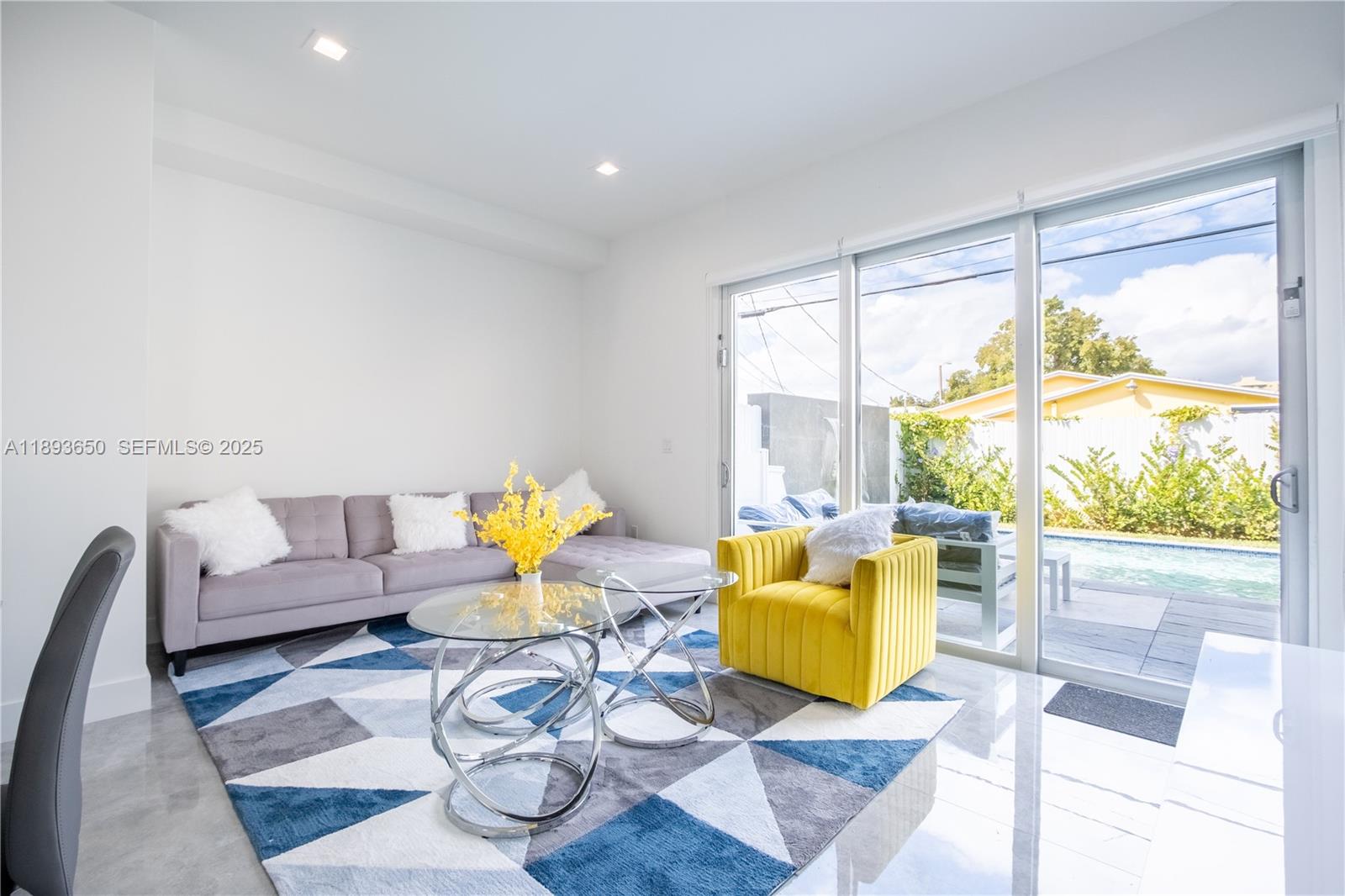 3461 Southwest 25th Street, Unit B Miami, FL 33133 - Photo 7 of 23 a living room with furniture and a large window