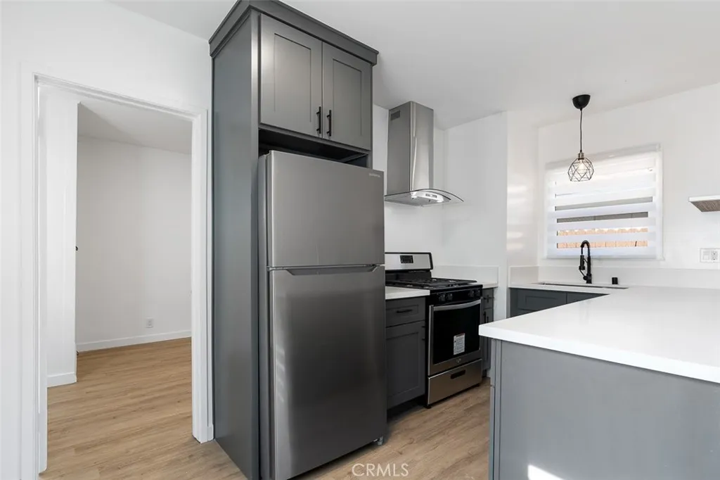 411 North Euclid Avenue Pasadena, CA 91101 - Photo 9 of 40 a kitchen with stainless steel appliances a refrigerator and a sink
