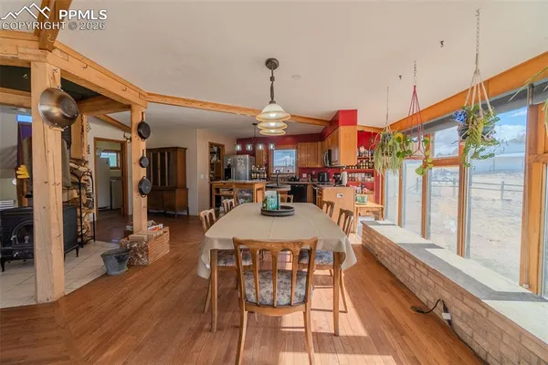 a kitchen with stainless steel appliances a stove a sink dishwasher and a refrigerator with wooden floor