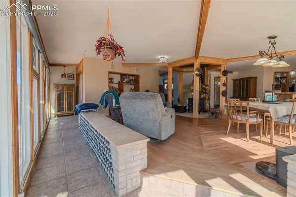 a view of a dining room with furniture chandelier and a rug