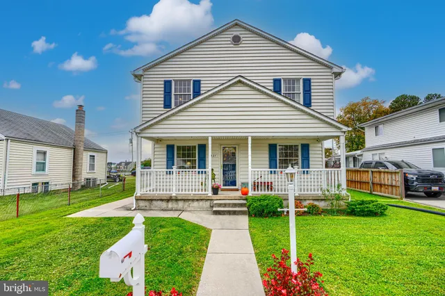 a front view of a house with a yard table and chairs