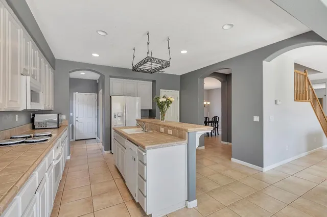 a open kitchen with stainless steel appliances granite countertop a sink stove and refrigerator
