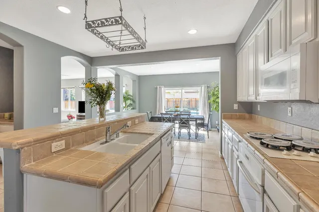 a kitchen with a sink stove and cabinets