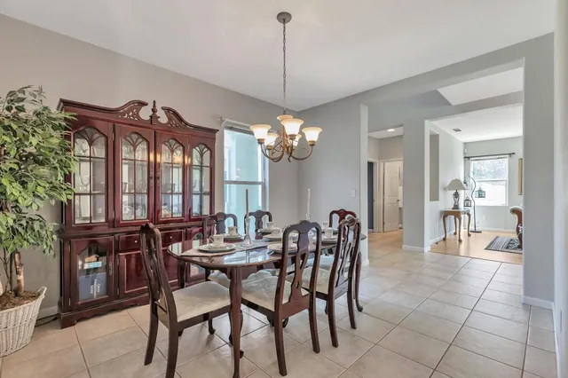 a view of a dining room with furniture and chandelier