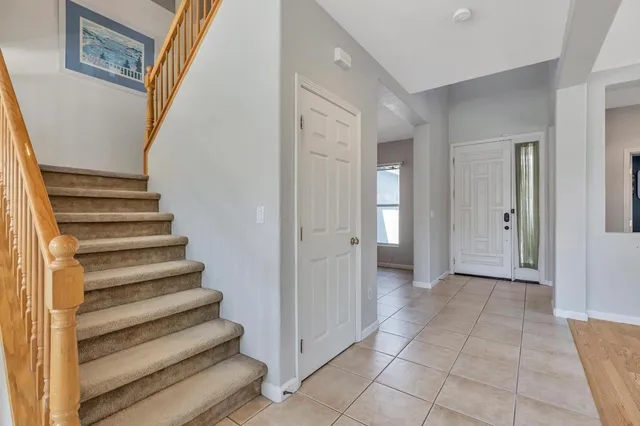 a view of a hallway with wooden floor and entryway