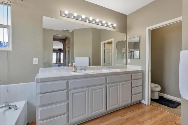 a bathroom with a double vanity sink and a mirror