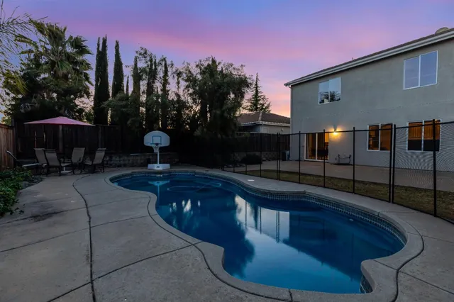 a swimming pool with outdoor seating yard and outdoor seating