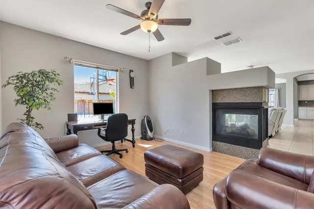 a living room with furniture a chandelier and a window