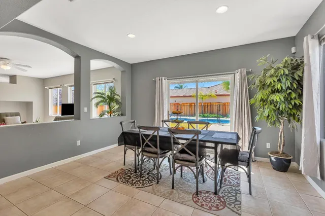 a dining room with furniture and window