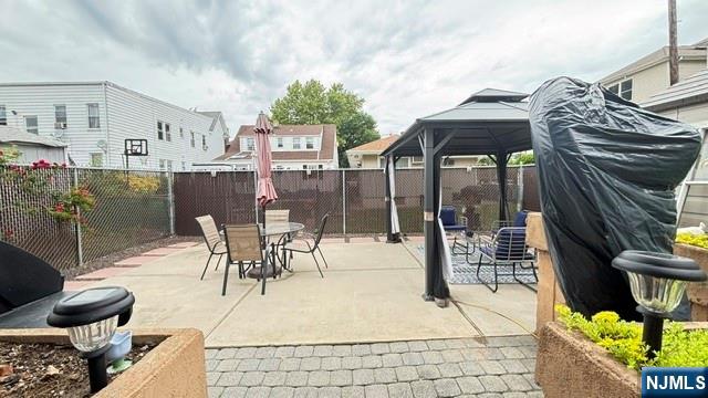 760 Hamilton Street, Unit 1 Harrison, NJ 07029 - Photo 20 of 23 a view of a patio with table and chairs potted plants with wooden floor